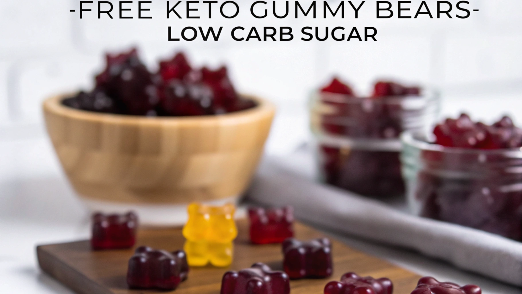 dark-red-gummy-bears-spilling-from-a-paper-bag-with-frozen-blackberries-in-a-bowl